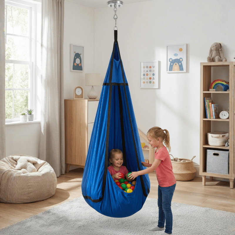 Sensory hammock swing pod for autism and ADHD, child sitting inside with play balls